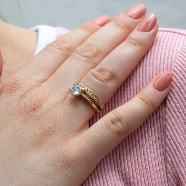 Conjunto de anillos de compromiso y matrimonio toma vida cuando es colocado en la mano de la pareja, añadiendo un toque de sofisticación